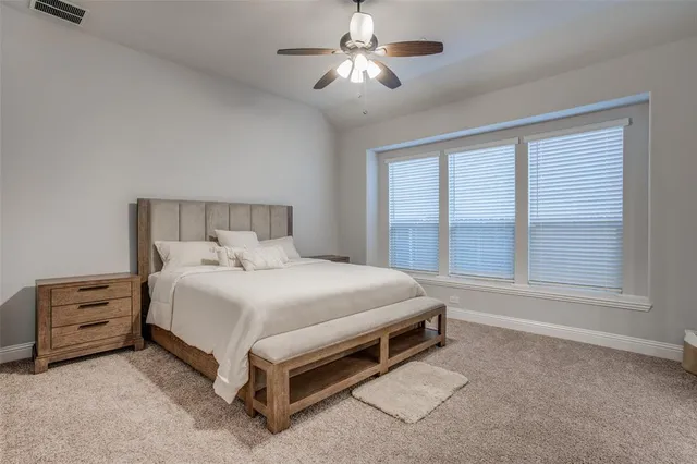 a bed sitting in a bedroom next to a window