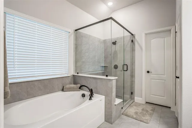 a bathroom with a bathtub and a shower