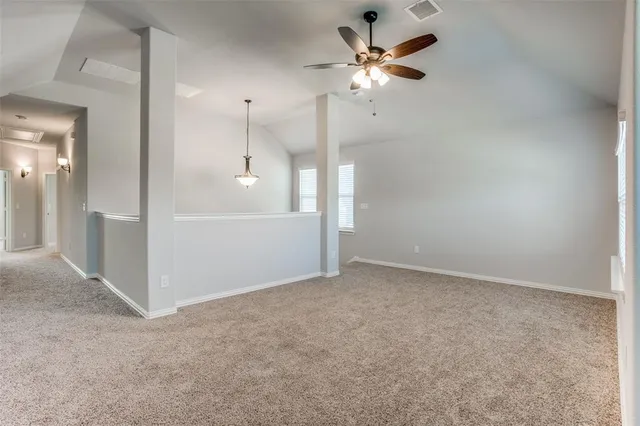 an empty room with fan and entrance