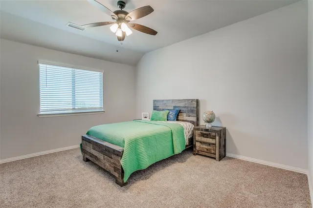 a bedroom with bed and a chandelier