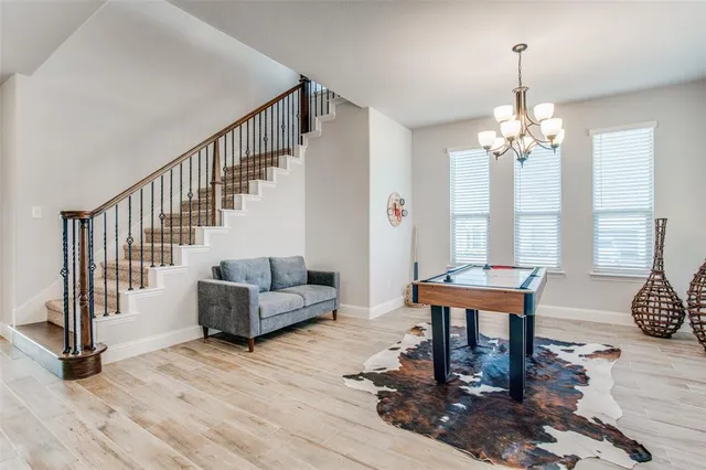 a living room with furniture and a chandelier