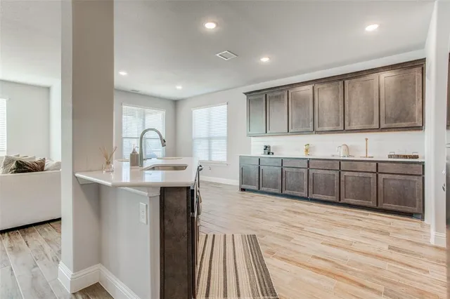 a kitchen with stainless steel appliances granite countertop a sink stove and cabinets