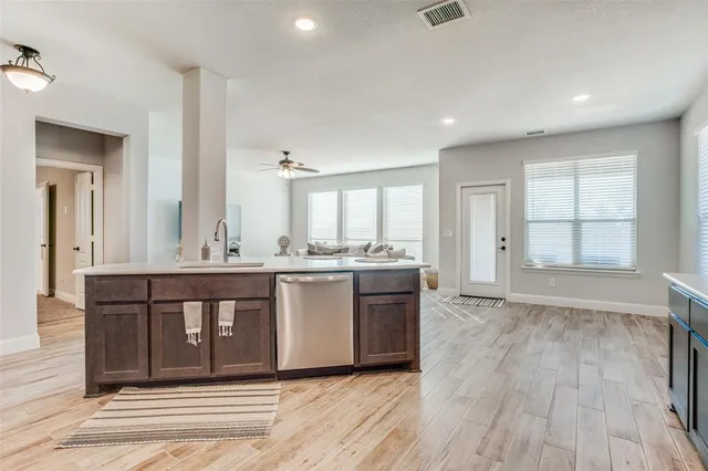 wooden floor with a kitchen counter top space and wooden floor