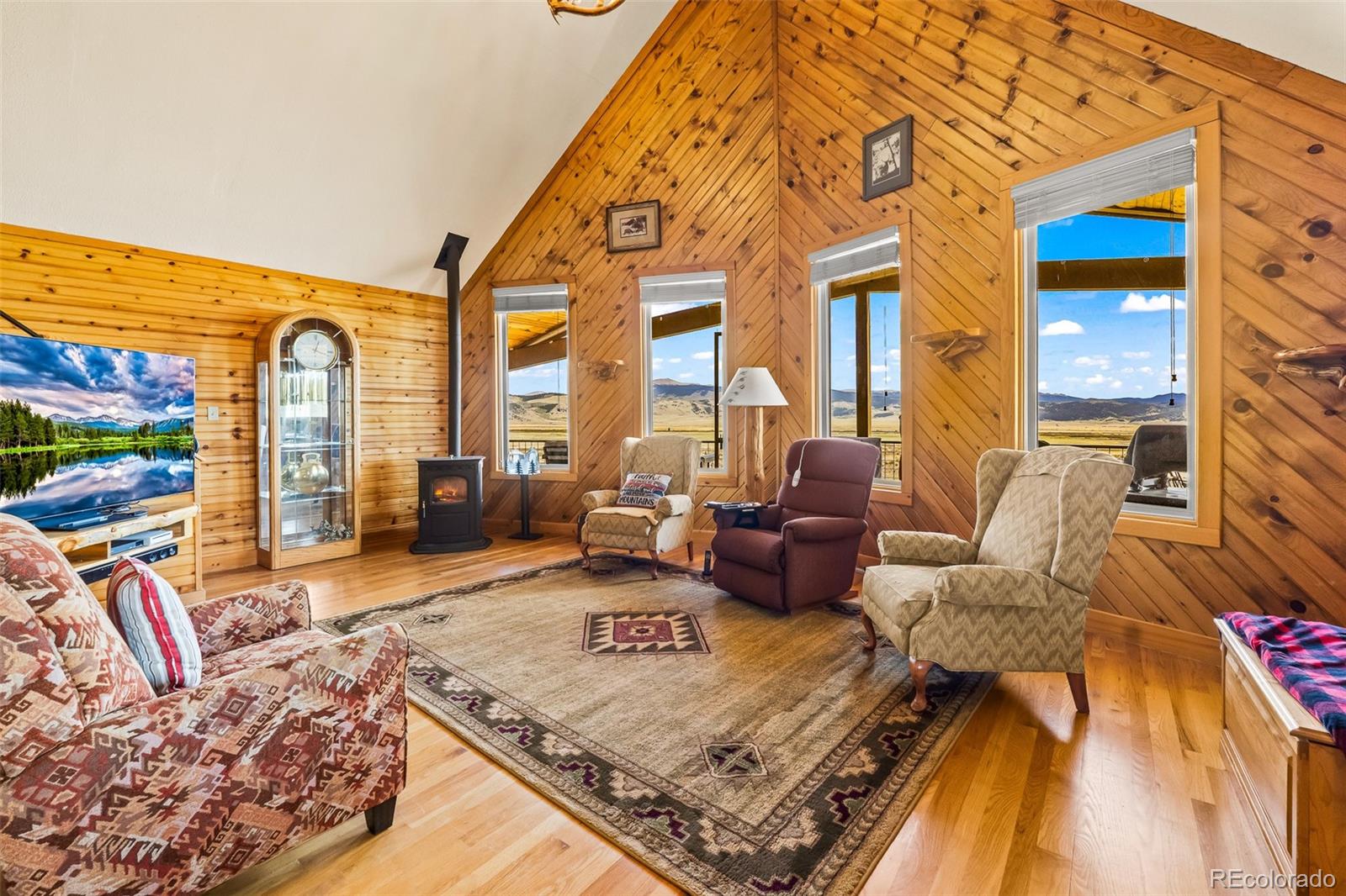 1163 Michigan Hill Road Jefferson, CO 80456 - Photo 15 of 48 a living room with furniture a rug and a floor to ceiling window
