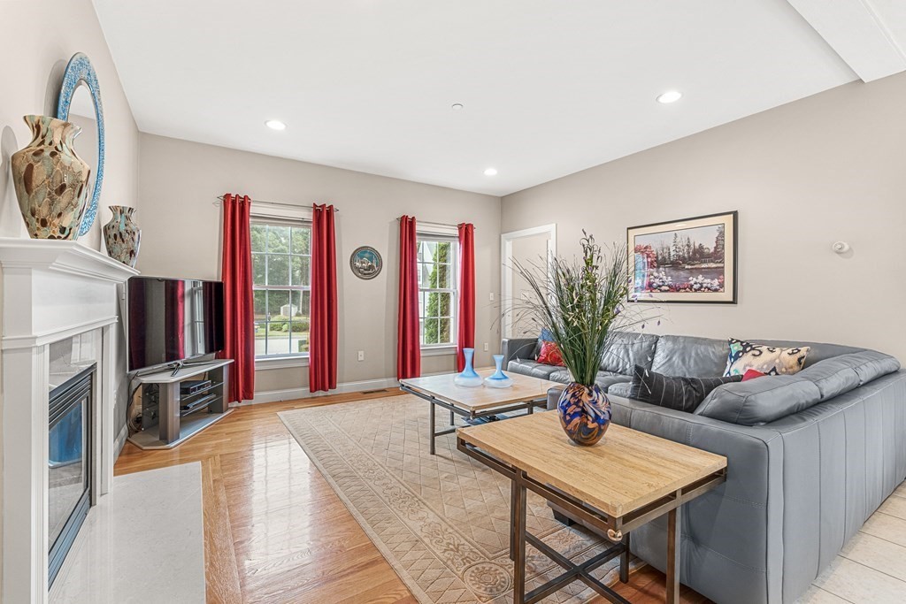 8 Rons Way Framingham, MA 01701 - Photo 12 of 33 a living room with fireplace furniture and a flat screen tv