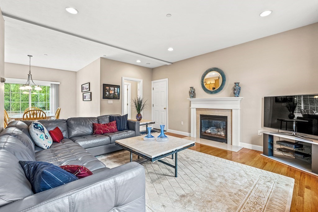 8 Rons Way Framingham, MA 01701 - Photo 14 of 33 a living room with furniture a clock and a fireplace