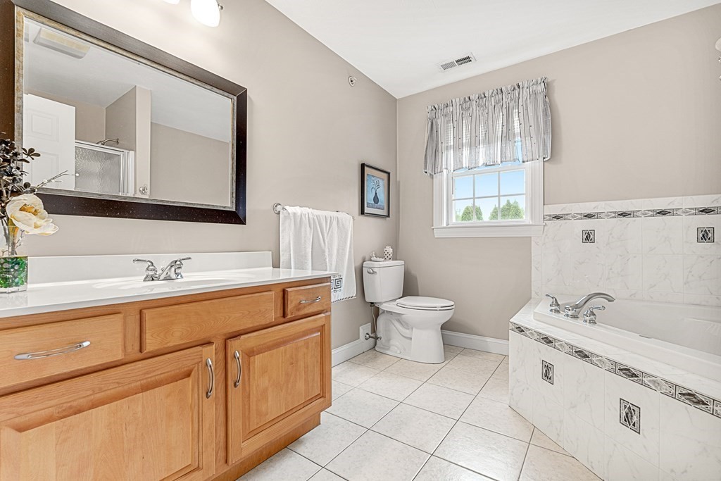 8 Rons Way Framingham, MA 01701 - Photo 19 of 33 a spacious bathroom with a sink double vanity and a mirror