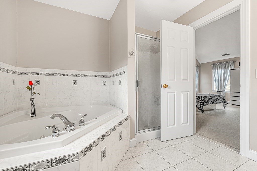 8 Rons Way Framingham, MA 01701 - Photo 20 of 33 a bathroom with a tub sink and mirror