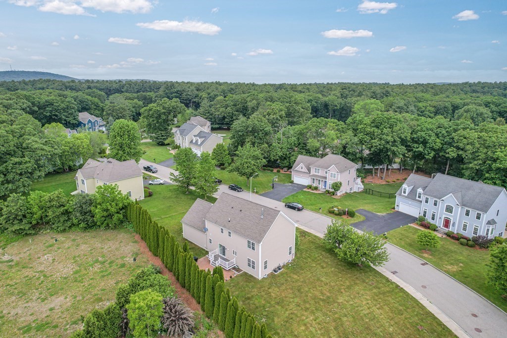 8 Rons Way Framingham, MA 01701 - Photo 31 of 33 an aerial view of a house with a garden and trees