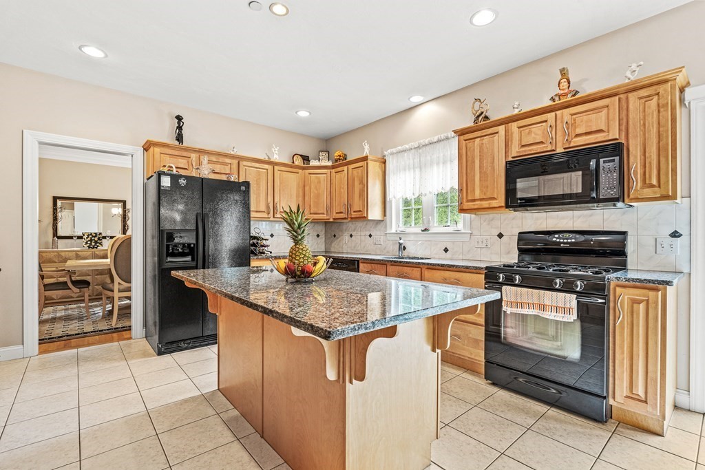 8 Rons Way Framingham, MA 01701 - Photo 4 of 33 a kitchen with stainless steel appliances granite countertop a stove top oven a sink dishwasher a refrigerator and a microwave