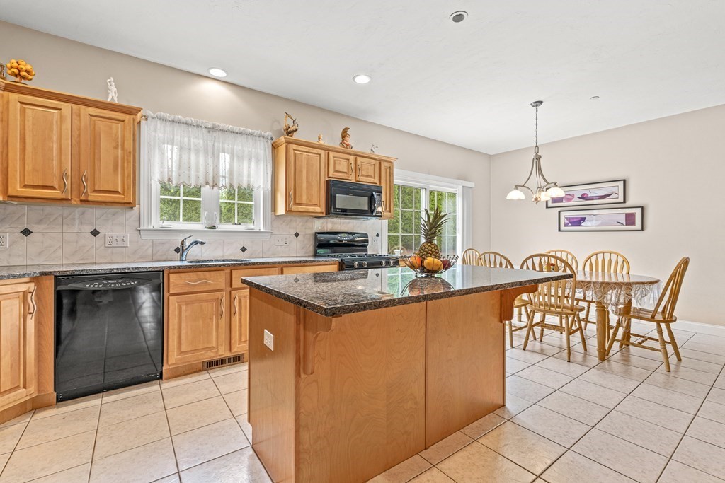 8 Rons Way Framingham, MA 01701 - Photo 7 of 33 a kitchen with stainless steel appliances granite countertop a stove top oven a sink dishwasher and white cabinets with wooden floor
