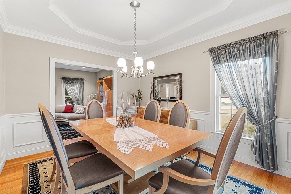 8 Rons Way Framingham, MA 01701 - Photo 8 of 33 a view of a dining room with furniture and a chandelier