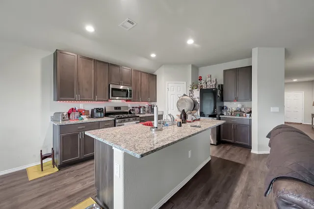 a kitchen with sink a stove and cabinets