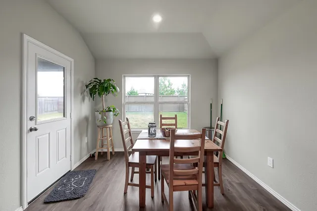 a view of a dining room with furniture and window