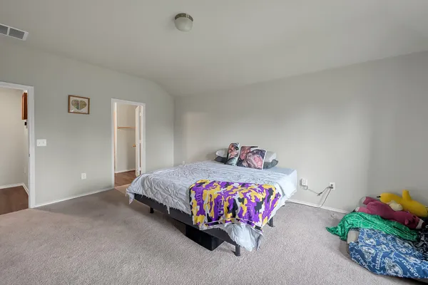 a bedroom with a bed and a table