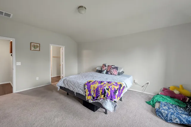 a bedroom with a bed and a table