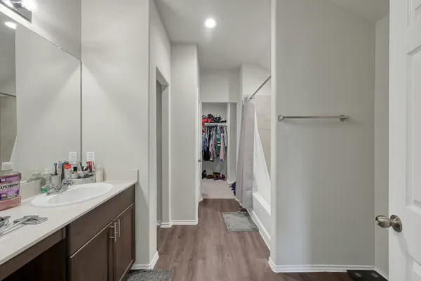 a bathroom with a sink vanity and a mirror