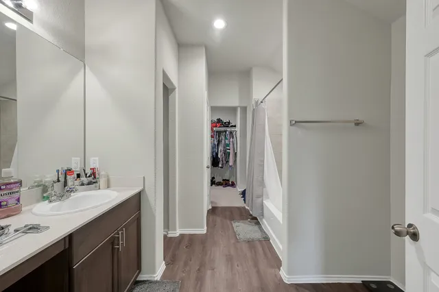 a bathroom with a sink vanity and a mirror