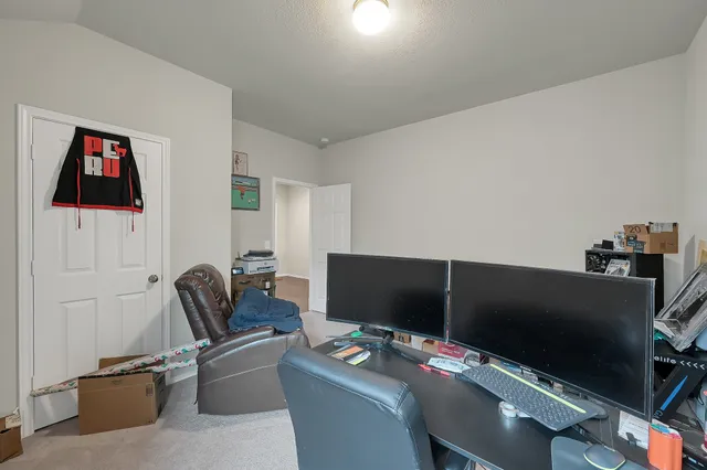 a work room with furniture and flat screen tv