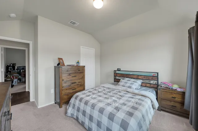 a bedroom with a bed and a television