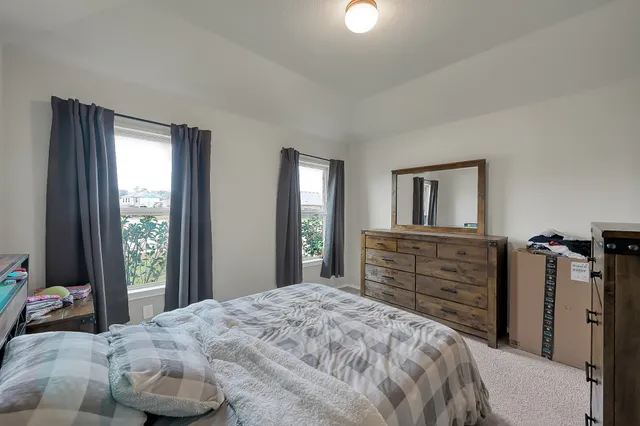 a bedroom with a bed and a dresser