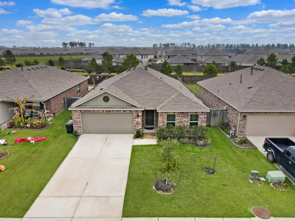 an aerial view of a house with yard