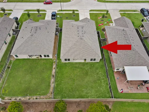 an aerial view of a house with a yard