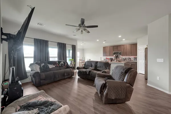 a living room with furniture and a ceiling fan