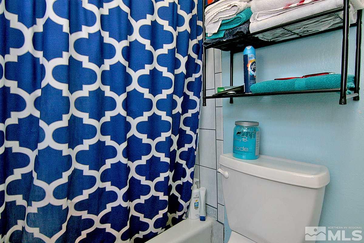 530 East Taylor Street Reno, NV 89502 - Photo 11 of 25 a bathroom with a toilet and a shower curtain