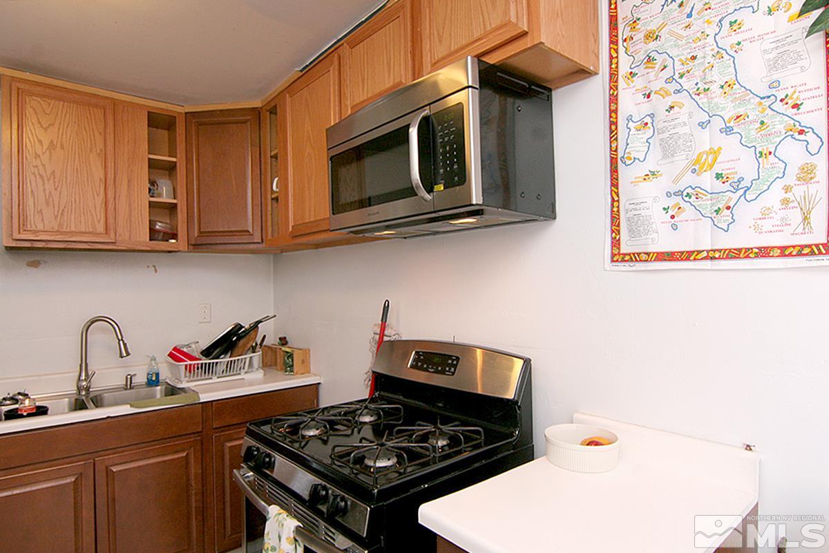 530 East Taylor Street Reno, NV 89502 - Photo 14 of 25 a kitchen with stainless steel appliances a stove and a microwave
