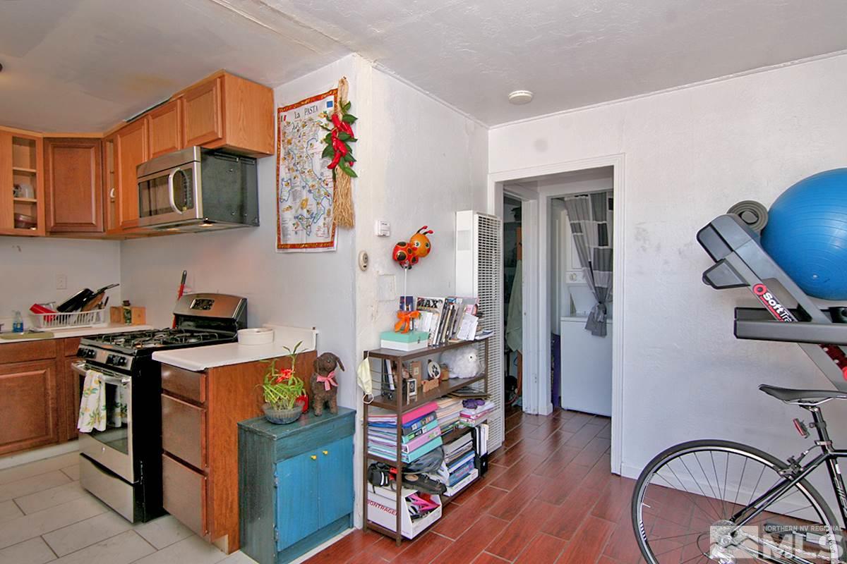 530 East Taylor Street Reno, NV 89502 - Photo 15 of 25 a room with stainless steel appliances granite countertop a stove top oven a sink and a refrigerator