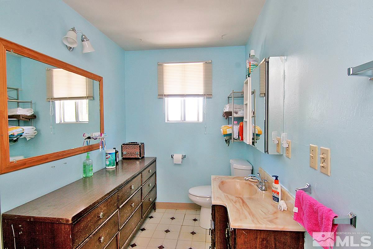 530 East Taylor Street Reno, NV 89502 - Photo 8 of 25 a bathroom with a sink mirror vanity and a bathtub