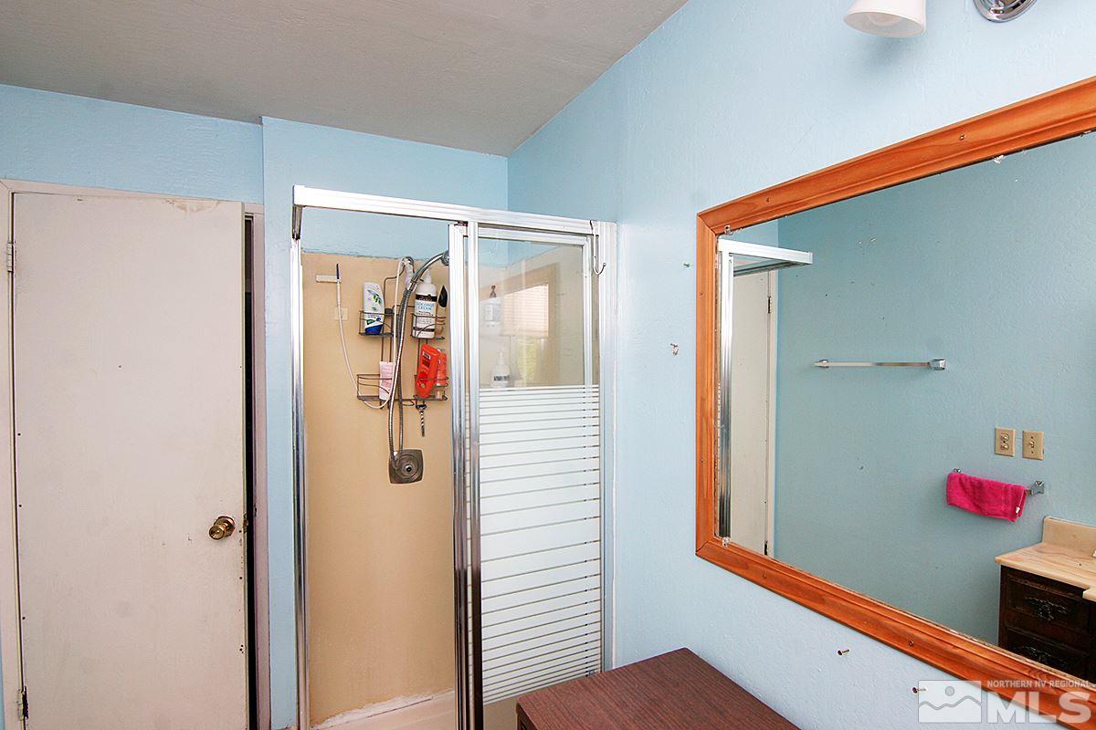530 East Taylor Street Reno, NV 89502 - Photo 9 of 25 a bathroom with a shower and a mirror