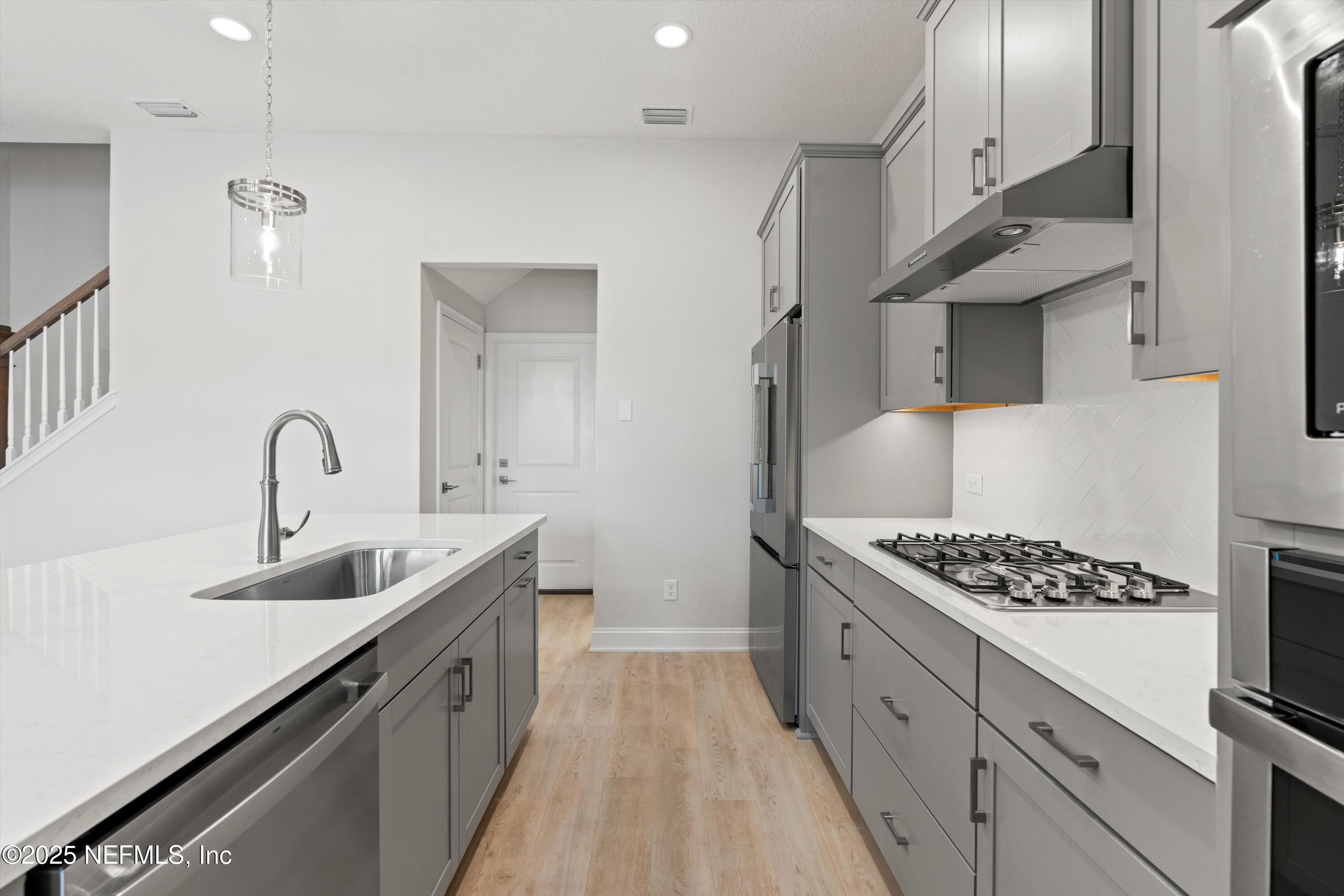 68 Sewall Lane Ponte Vedra, FL 32081 - Photo 11 of 39 a kitchen with stainless steel appliances a sink stove and cabinets