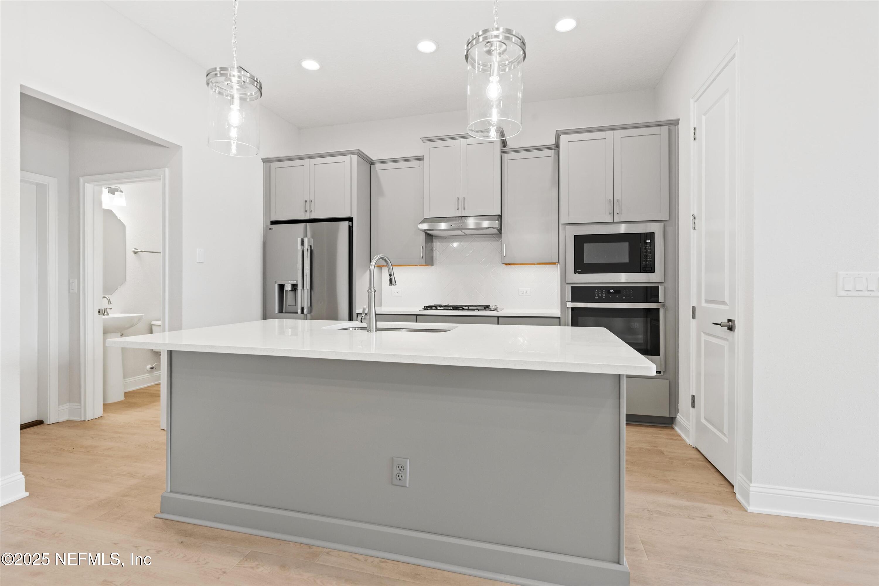 68 Sewall Lane Ponte Vedra, FL 32081 - Photo 12 of 39 a large kitchen with cabinets and stainless steel appliances