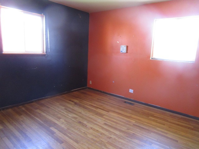 75 Tweed Road Fox Lake, IL 60020 - Photo 11 of 17 an empty room with wooden floor and windows