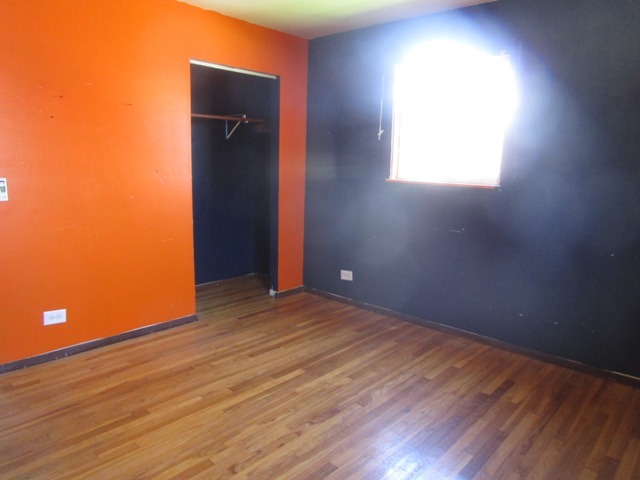 75 Tweed Road Fox Lake, IL 60020 - Photo 12 of 17 an empty room with wooden floor and windows