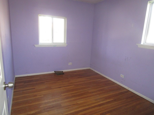 75 Tweed Road Fox Lake, IL 60020 - Photo 14 of 17 an empty room with wooden floor and windows