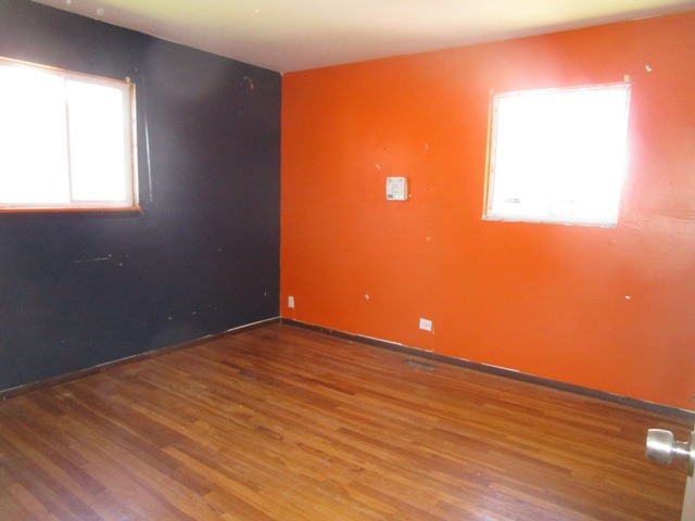 75 Tweed Road Fox Lake, IL 60020 - Photo 15 of 17 an empty room with wooden floor and windows