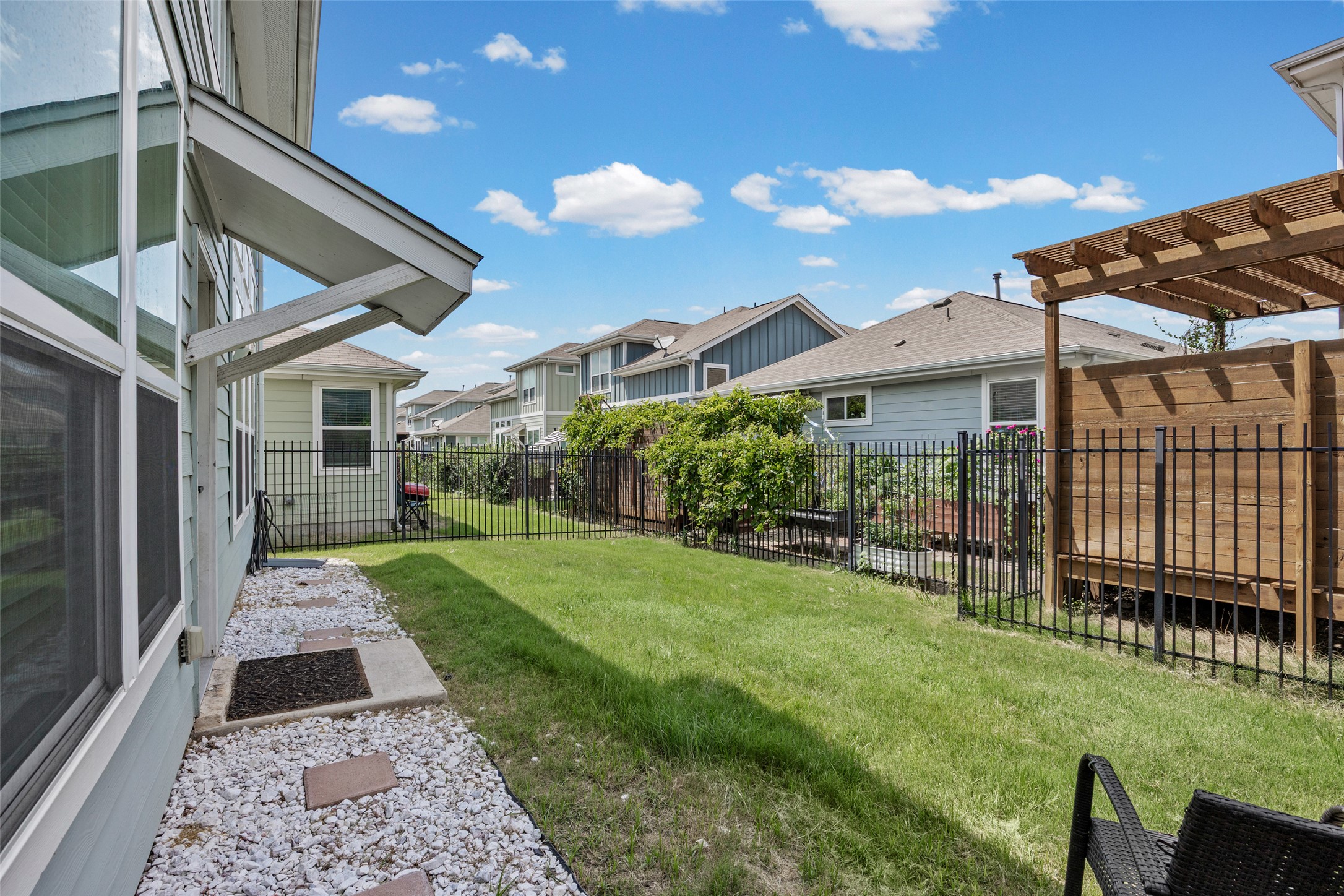 1408 Homespun Road Austin, TX 78745 - Photo 20 of 20 A private yard with an iron fence, providing ample space for outdoor enjoyment.