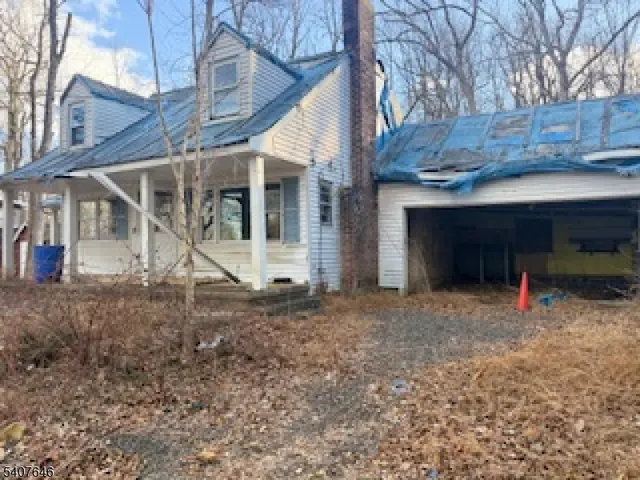 a view of a house with a backyard space and wooden deck