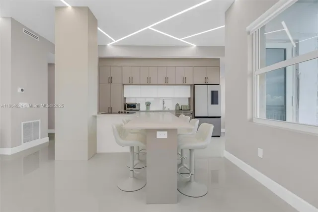 a kitchen with cabinets and chairs