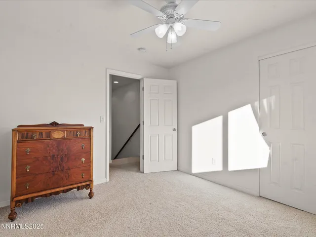 a living room filled with furniture and floor to ceiling windows