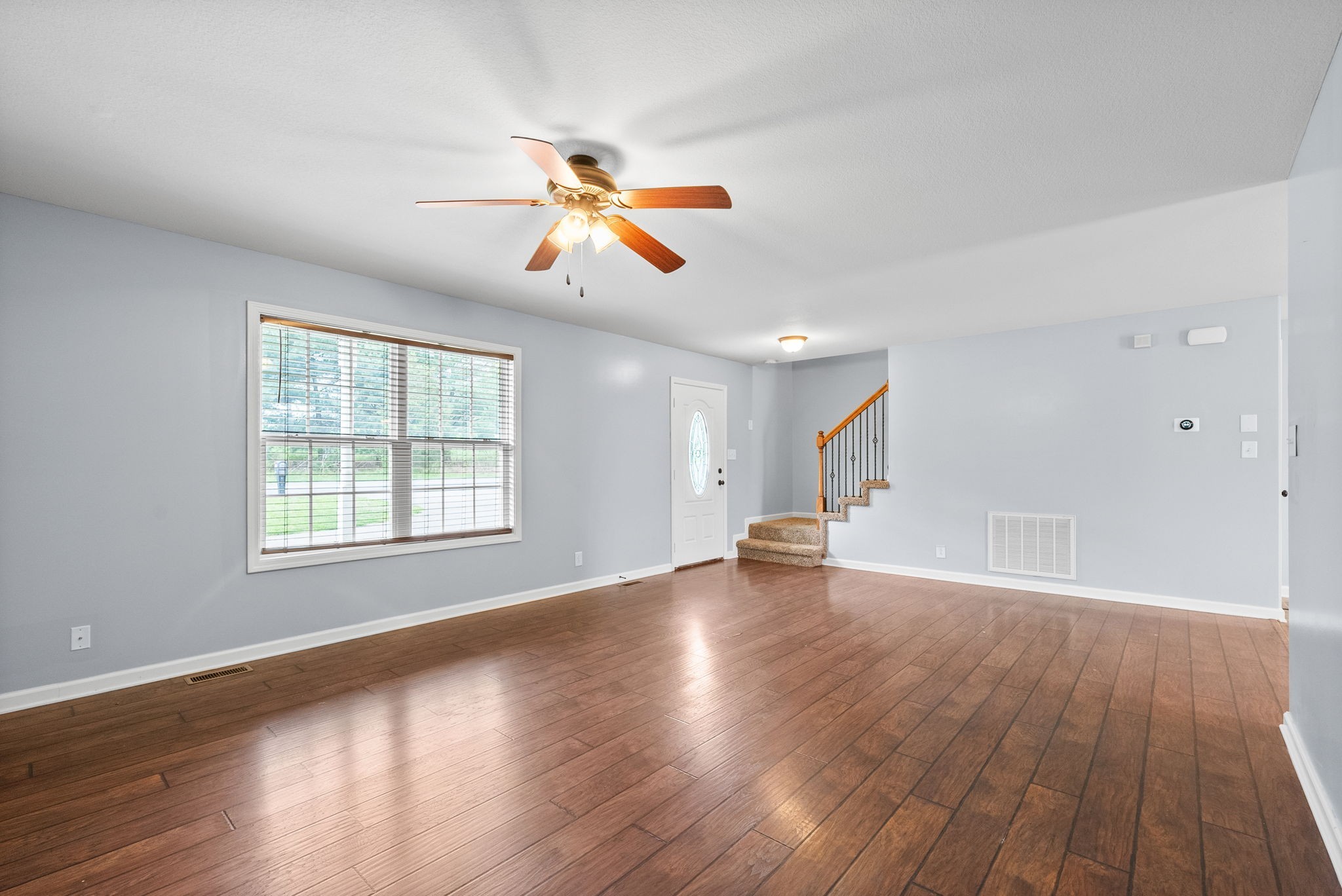 1563 Hazelwood Road Clarksville, TN 37042 - Photo 11 of 43 an empty room with wooden floor and windows