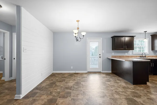 a kitchen with refrigerator and stove