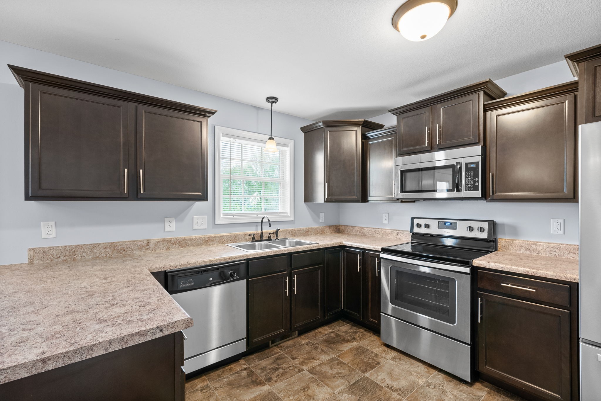 1563 Hazelwood Road Clarksville, TN 37042 - Photo 15 of 43 a kitchen with stainless steel appliances granite countertop a sink stove and microwave