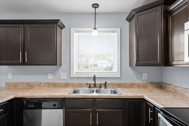a kitchen with a sink and refrigerator