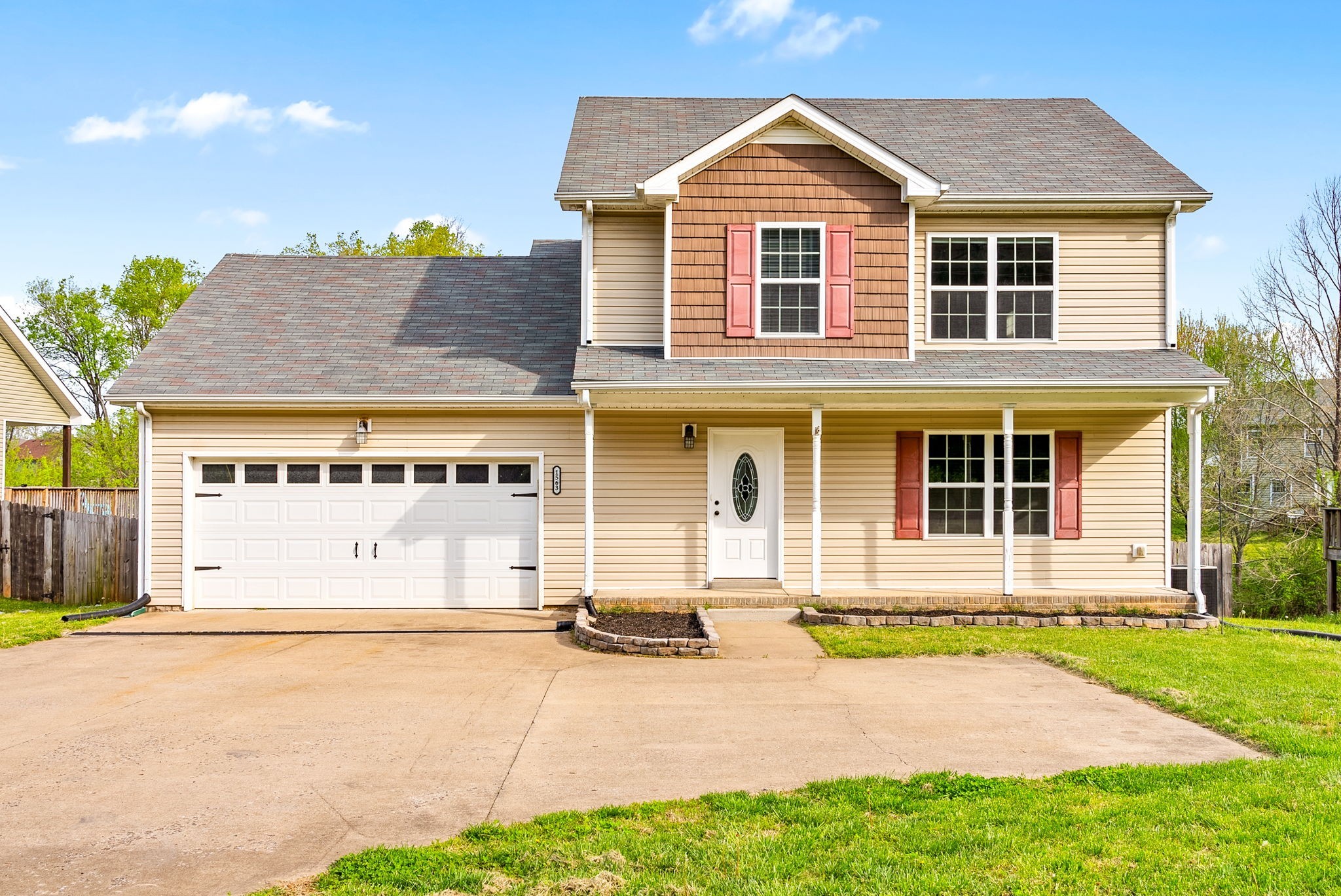 1563 Hazelwood Road Clarksville, TN 37042 - Photo 2 of 43 a front view of a house with a yard and garage
