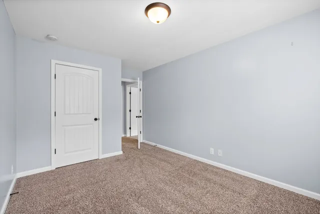 a bathroom with a granite countertop sink toilet a shower and a mirror