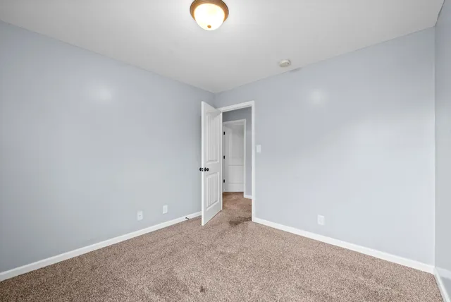 an empty room with a empty space and windows